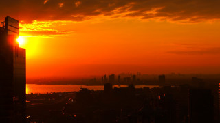 Sunset city river skyline embers - a large body of water free wallpaper