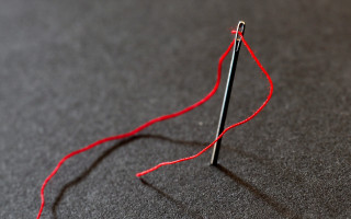 Red thread knitting needle string - a cross stitch free wallpaper