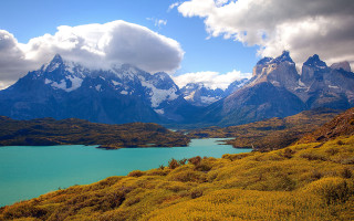 Mountain lake snowcapped peaks beautiful - a lake in the foreground and a mountain range in the background free wallpaper