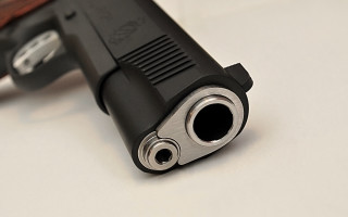 Gun wooden barrel white surface - a black handle free wallpaper