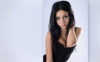 Gothic woman black hair portrait - her right arm behind her head free wallpaper