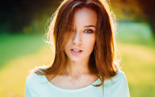 Woman blue green shirt green - a green field in the background free wallpaper