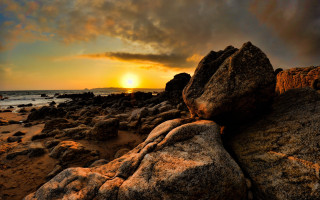 Sunset rocky beach boat mountain 2 - a sunset over a rocky beach free wallpaper