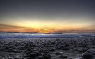 Beach rocks sunset wave mountain - the sand and a sunset in the background free wallpaper