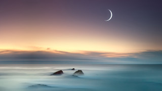Crescent ocean sunset moon rocks - a moon in the sky above free wallpaper