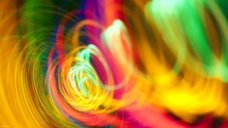 Colorful light swirls kinetic art - a blurry photo free wallpaper for desktop