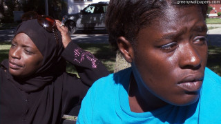 Woman putting on headscarf watching - the side of the street free wallpaper