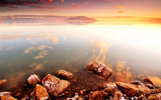 Rocky shore water sunset cloudy - arthur quartley free wallpaper