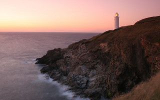 Lighthouse cliff ocean sunset pink 10 - radiant light free wallpaper for desktop