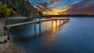 Lake sunset clouds bridge city - a body of water below free wallpaper