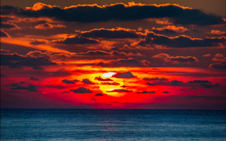 Sunset clouds boat water red - the water below free wallpaper