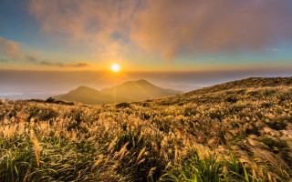 Sunset grassy hill mountain clouds - sunrise free wallpaper