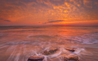 Sunset ocean rocks clouds beach - the water and a sky free wallpaper