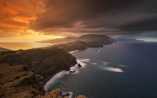 Sunset coastline mountains water clouds - a rocky coastline free wallpaper