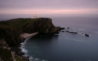Lighthouse cliff ocean dusk pink - a pink sky above free wallpaper