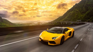Yellow sports car mountain sunset - dramatic free wallpaper