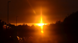 Bright sunset orange sky cityscape - a bright sun free wallpaper