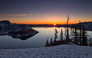 Sunset lake trees snow mountain - orange sun free wallpaper