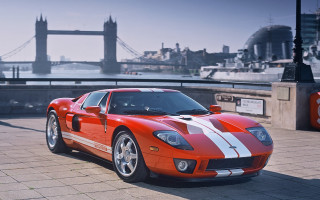 Red sports car bridge tower - a bridge in the background free wallpaper