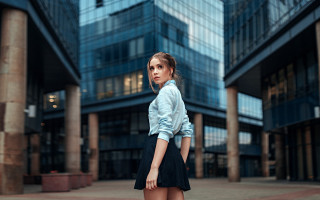 Woman building suitcase cityscape neoism - her hand and a building in the background free wallpaper