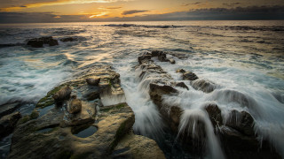 Rocky shore waves sunset clouds 3 - the distance behind free wallpaper