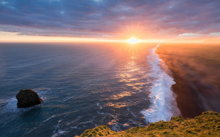 Sunset ocean rock formation sky - a sunset over the ocean free wallpaper