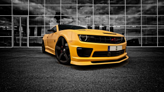Yellow sports car building cloudy - window free wallpaper