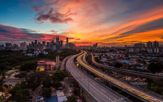 City skyline highway train sunset - a colorful sky in the background free wallpaper