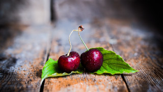 Cherries green leaves wooden table - a wooden table free wallpaper for desktop