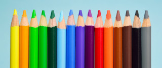 Colored pencils child drawing complementary - a blue background behind them free wallpaper