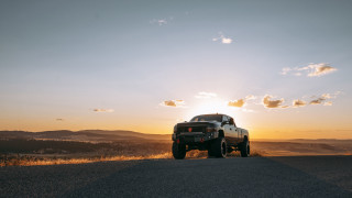 Truck sunset clouds mountains ocean - octane free wallpaper
