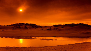 Sunset mountain water clouds red - a sunset over a body of water free wallpaper