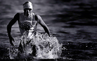 Man wet suit running water - his hand and a helmet free wallpaper