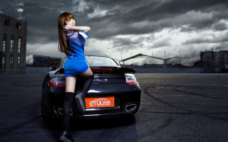 Woman blue dress car parking - a cloudy sky behind her free wallpaper