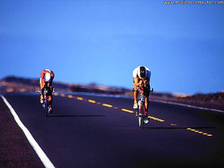 Two men biking sunny day - a road next free wallpaper