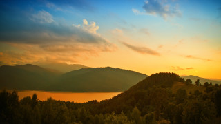 Sunset mountain lake trees horizon 2 - a sunset over a mountain free wallpaper