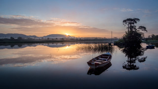 Boat sunset mountain lake dusk - a mountain in the background and a lake in the foreground free wallpaper