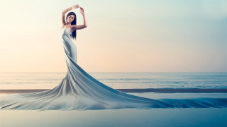 Woman beach arms up ocean - a long dress free wallpaper