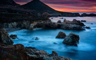 Rocky beach mountain sunset water - a red sky free wallpaper