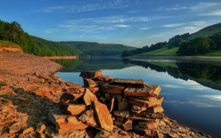 Lake shore rocks mountains blue - a pile of rocks free wallpaper