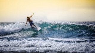 Man surfing wave ocean sky - a yellow sky free wallpaper for desktop