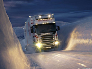 Truck driving snowy road night - scene free wallpaper
