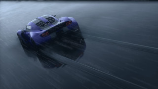 Blue racecar speeding foggy racetrack - a blue race car free wallpaper