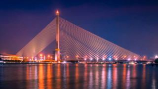 Large bridge cityscape night floodlights - a large bridge over a body of water free wallpaper