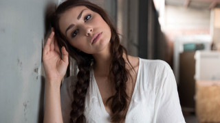 Woman portrait araceli gilbert braided - a woman leaning against a wall free wallpaper