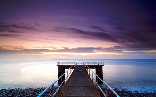 Pier rail ocean sunset clouds - rich moody colour free wallpaper