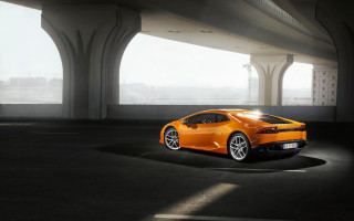 Bright orange sports car bridge - a parking lot free wallpaper