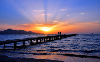 Pier sunset ocean mountain boat - sunset over the ocean free wallpaper