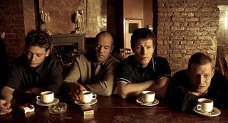 Men sitting table coffee brick - a brick wall behind them free wallpaper