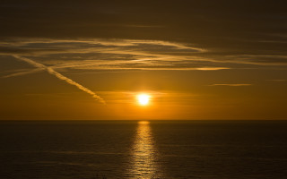Sunset ocean contrail boat lensflare - free sunset wallpaper for desktop